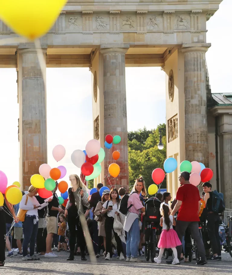 Ansammlung von Menschen mit Luftballons vor dem Brandenburger Tor